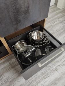 a drawer filled with pots and pans in a kitchen at Ferienwohnung Weitblick in Naumburg +24 photos