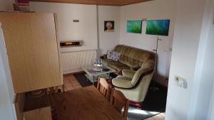 a living room with a couch and a table at Haus Ilse in Waren