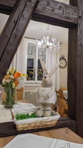 a stuffed rabbit sitting on a table in a dining room at Quartier Goldener Löwe in Günthersleben