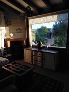 a living room with a large window and a table at A Boira Rural in Osia