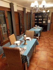 a dining room with two tables and chairs at A Boira Rural in Osia