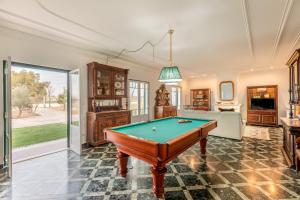 a living room with a pool table at Quinta da Pinheira Lezíria in Alpiarça