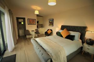 a bedroom with a bed and a living room at The Shepherd's Lodge in Tullyallen