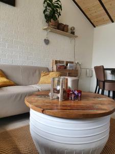 a coffee table in a living room with a couch at Vakantiehuis Elisa Zuid Limburg in Simpelveld