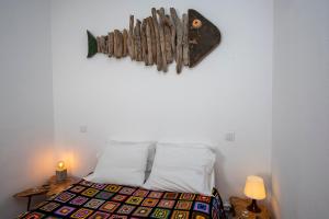 a bedroom with a bed and a wall with aigunigunigun at Hillside 2 Aljezur old town in Aljezur