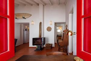 a living room with a red door and a television at Hillside 2 Aljezur old town in Aljezur