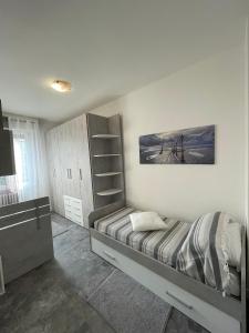 a bedroom with a bed and a book shelf at Magic Apartments in Bardolino