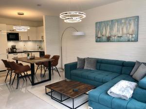 a living room with a blue couch and a table at Ferienwohnung Ostsee Timmendorferstrand in Timmendorfer Strand