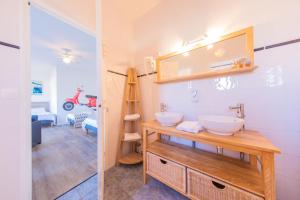 a bathroom with a sink and a mirror at Hôtel Land'Azur in Mimizan-Plage