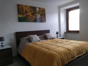 a bedroom with a bed and a painting on the wall at Monte Zucco Relax in San Pellegrino Terme