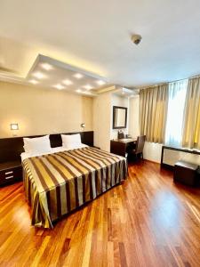 a hotel room with a bed and a desk at City Boutique Hotel in Sarajevo