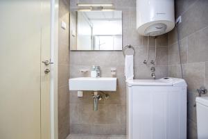 a bathroom with a sink and a mirror at Mateja&Fontana Apartment in Budva +74 photos