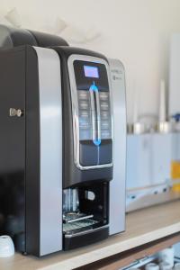 a drink machine sitting on a counter in a kitchen at Hôtel Land'Azur in Mimizan-Plage