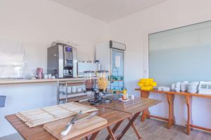 a kitchen with a wooden table in a room at Hôtel Land'Azur in Mimizan-Plage