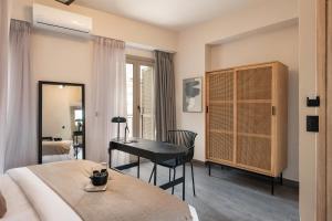 a bedroom with a desk and a bed and a desk at Anaem Eclectic Rooms in Chania