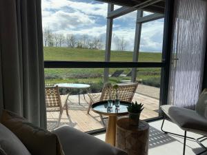 a living room with a view of a patio at B&B Veluwemeer in Biddinghuizen