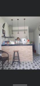 a kitchen with a counter and a table in a kitchen at บ้านสวนปลายนา Ban Suan Plai Na in Ban Kaeng Tat Sai