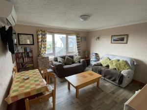 a living room with a couch and a table at Royal Oak Guesthouse in Orkney