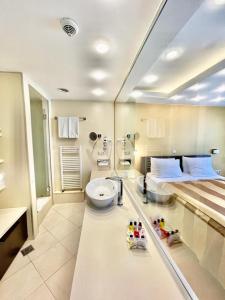 a bathroom with a bed and a toilet in it at City Boutique Hotel in Sarajevo