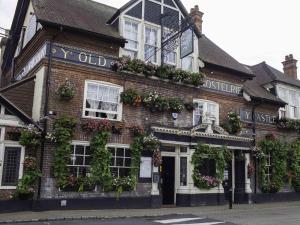an old brick building with lots of plants on it at The Castle Inn Hotel Bramber in Steyning