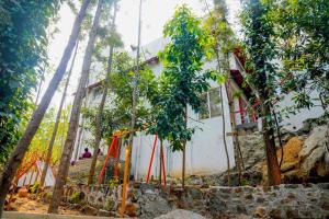 a house under construction with trees around it at Bhavan Resorts in Yercaud