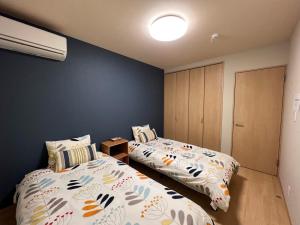 Postel nebo postele na pokoji v ubytování Guesthouse Kaede Annex