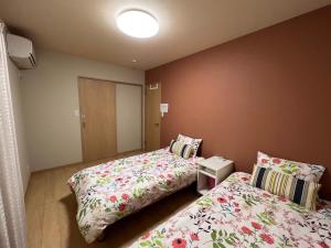Postel nebo postele na pokoji v ubytování Guesthouse Kaede Annex