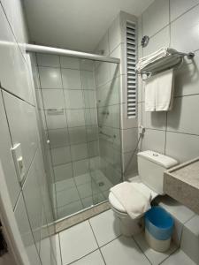 a bathroom with a glass shower and a toilet at Gran Lençois Flat Residence - Barrerinhas (Aptº Particular) in Barreirinhas +18 photos