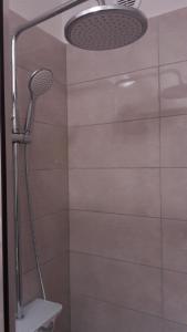 a shower with a shower head in a bathroom at EMA HOUSE in Zadar