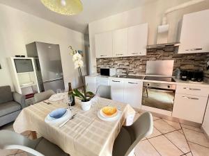 a kitchen and dining room with a table and chairs at House Viareggio in Viareggio