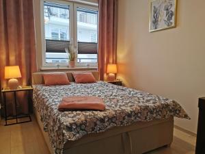 Posteľ alebo postele v izbe v ubytovaní Markowe Apartamenty Złoty Park