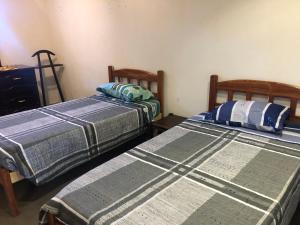 2 Betten nebeneinander in einem Zimmer in der Unterkunft Ballivian in Tarija