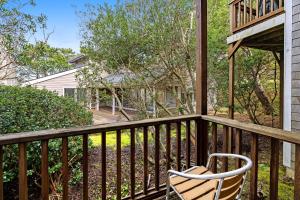 a wooden balcony with a chair on it at South Hemlock in Cannon Beach