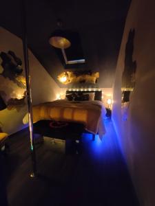 a bedroom with a bed with a blue light at La tentation in Berck-sur-Mer
