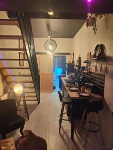 a kitchen with a table and chairs in a room at La tentation in Berck-sur-Mer