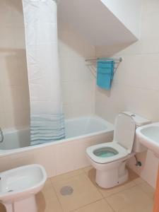 a bathroom with a toilet and a sink and a tub at Condado de Alhama N5 in Alhama de Murcia