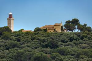 a house on top of a hill with a lighthouse at Cap d Antibes, Salis beach , 2 bedrooms , free parking in Antibes