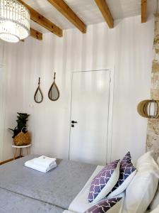 a bedroom with a bed and a chandelier at Mariviky design apartment in Chania