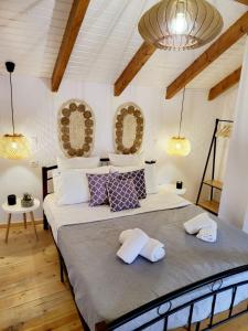 a bedroom with a large bed with two pillows at Mariviky design apartment in Chania Town