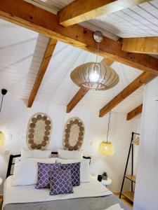 a bedroom with a bed and a ceiling with beams at Mariviky design apartment in Chania Town