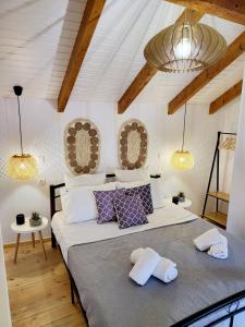 a bedroom with a large bed with two pillows at Mariviky design apartment in Chania