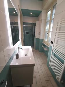 a bathroom with a white sink and a shower at B&B Ad Quintum Torino in Collegno
