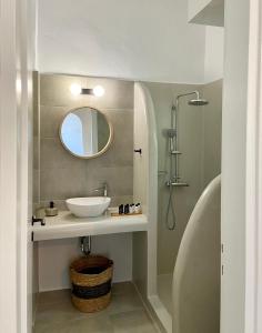 a bathroom with a sink and a mirror at Batsi Seaside Apartment in Batsi