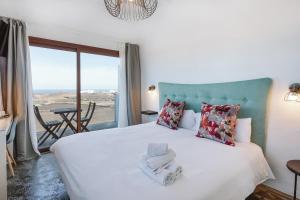 a bedroom with a bed with a view of the ocean at Casa De La Nobleza in Tinajo