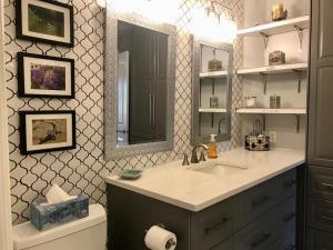 a bathroom with a sink and a mirror at Little Bear Garden View Suites-Hummingbird in Royston