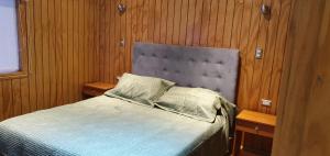 a bedroom with a bed and two night stands at El Capitán in Puerto Montt