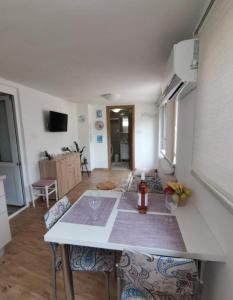 a kitchen with a table with two chairs and a counter top at Apartman Ane - Bribir in Bribir