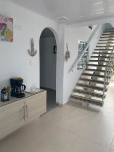 a staircase in a living room with a stair case at Summer Breeze in San Andrés