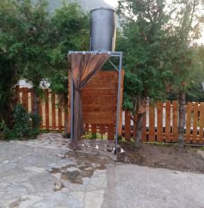 a wooden fence with a gate with a curtain at Popović na Drini in Bajina Bašta