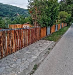 a wooden fence on the side of a road at Popović na Drini in Bajina Bašta